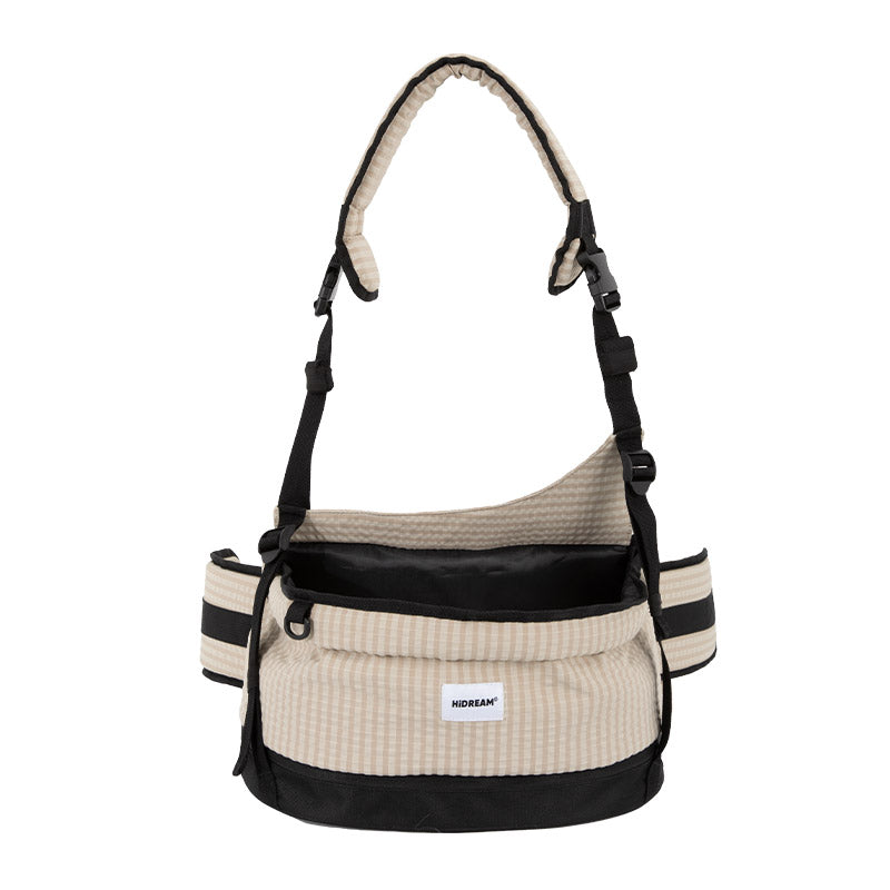 Pet hip seat carrier in vanilla beige with a padded crossbody strap and wide waist belt for everyday outings.